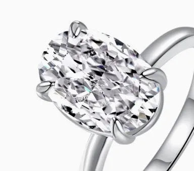 Oval women's silver ring with four-claw setting and cold luxury finish in gold or silver colours