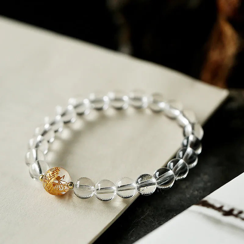 Geometric obsidian and white crystal beaded bracelet with golden dragon charm on adjustable band