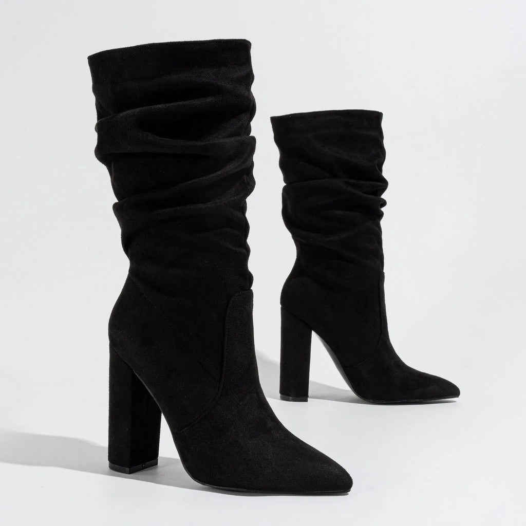 Women's black suede chunky heel pointed-toe boots with a high heel above 8cm and calf-length socks.