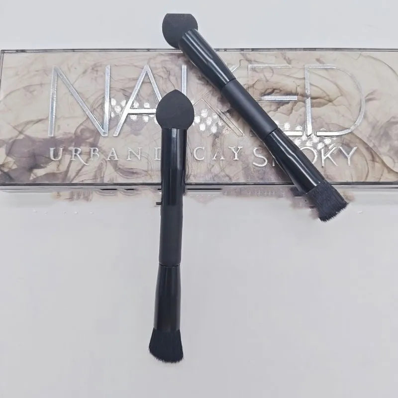 Black concealer brush with a tapered fibre head and wooden handle for makeup application.