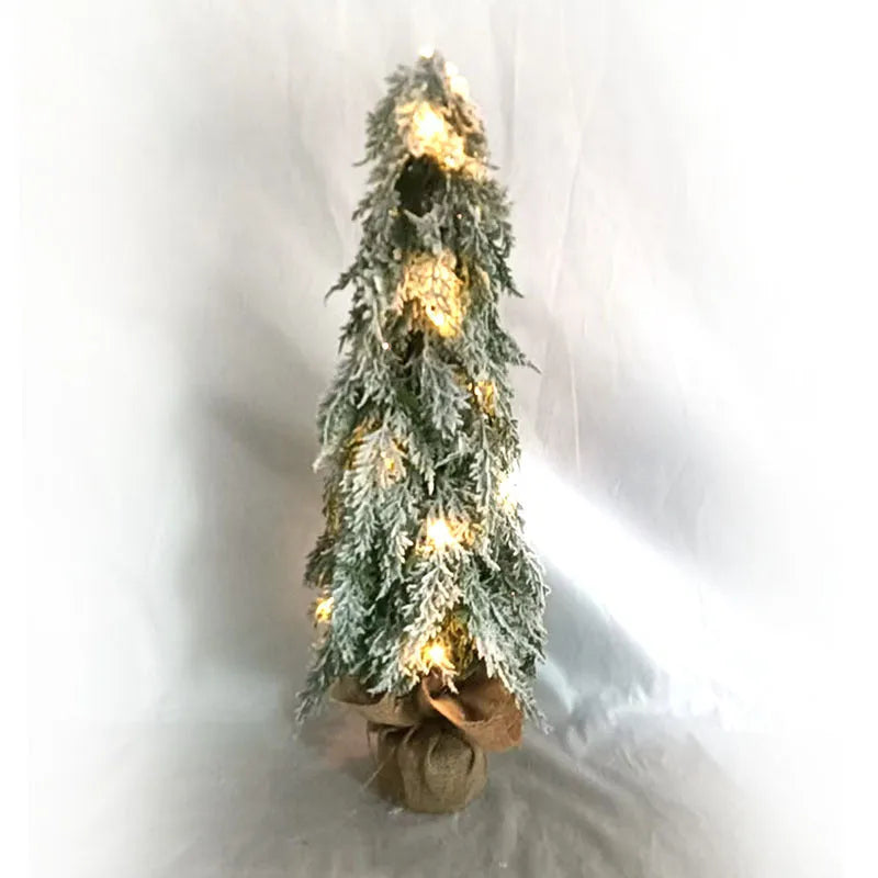 24-inch small artificial Christmas tree with snow spray decoration and built-in lights on desktop