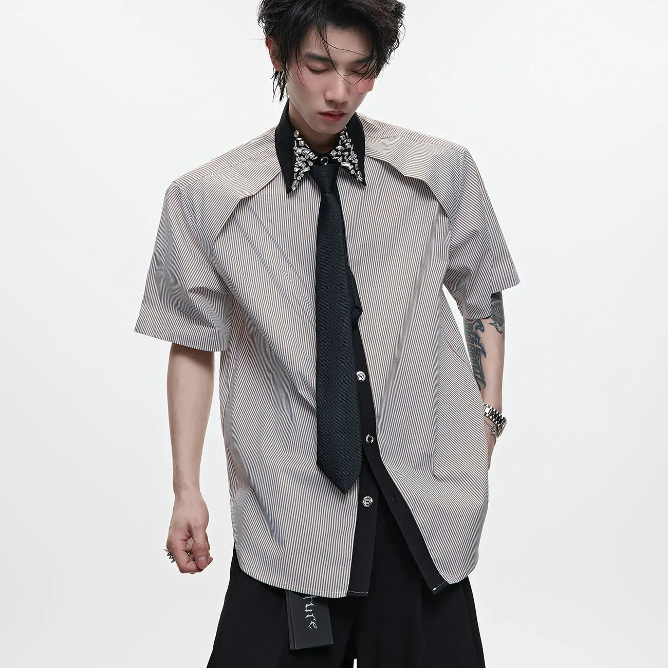 Men's blue and khaki patchwork striped shirt with diamond tie detail and quilted texture.