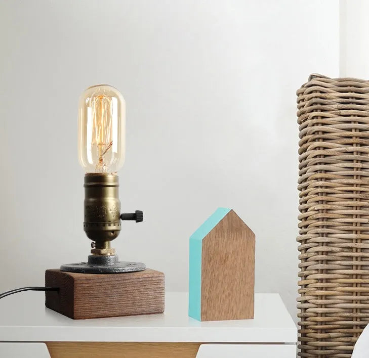 Industrial water pipe table lamp with wood and iron construction on tabletop