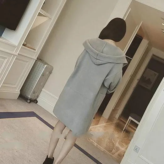 Plus size woman modelling a loose grey cotton coat with lace details for spring or autumn.