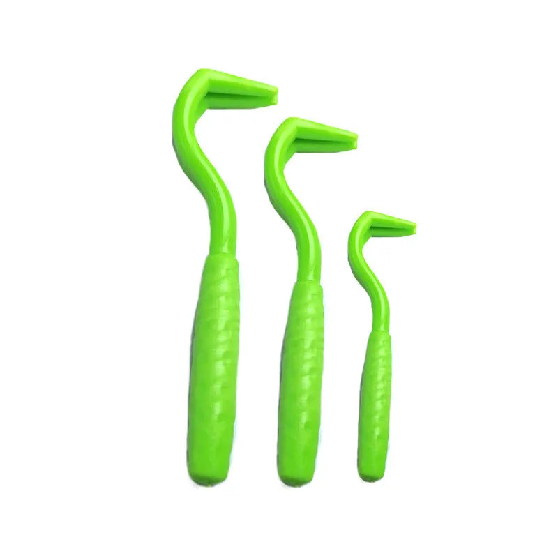 Three plastic tick removal hooks for dogs, shown in assorted colours on a white background.