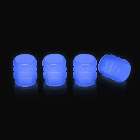 Pack of green and blue luminous rubber tyre valve caps on a car tyre valve.