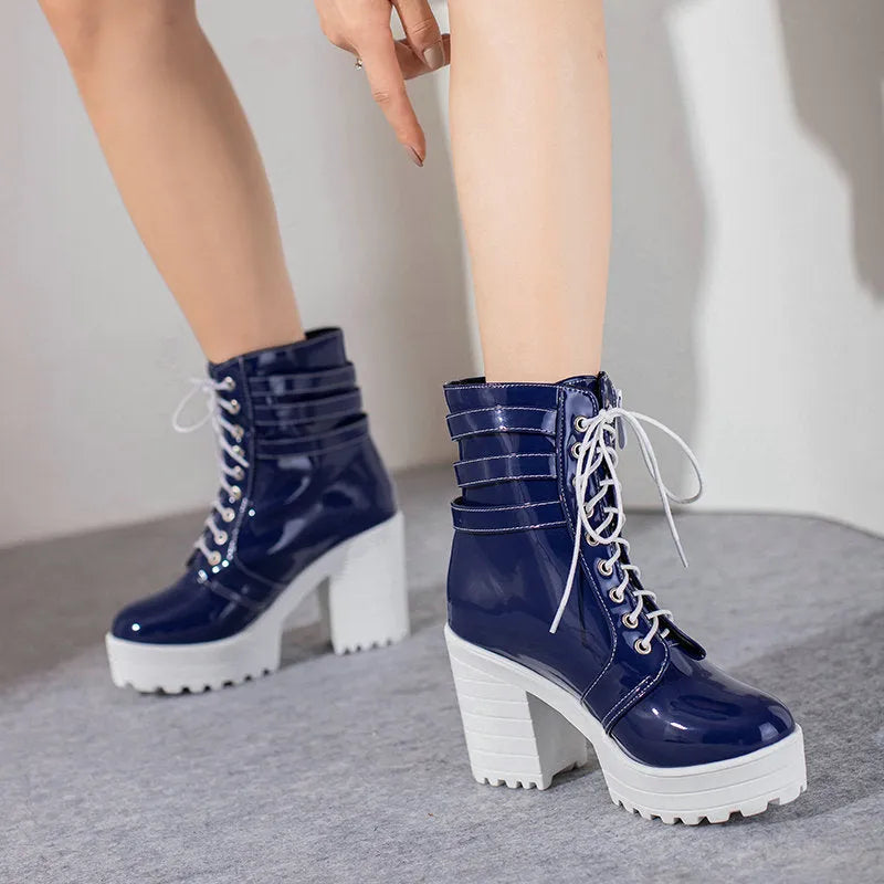 Women's black thick-heel ankle boots with round toe and front lace-up design.