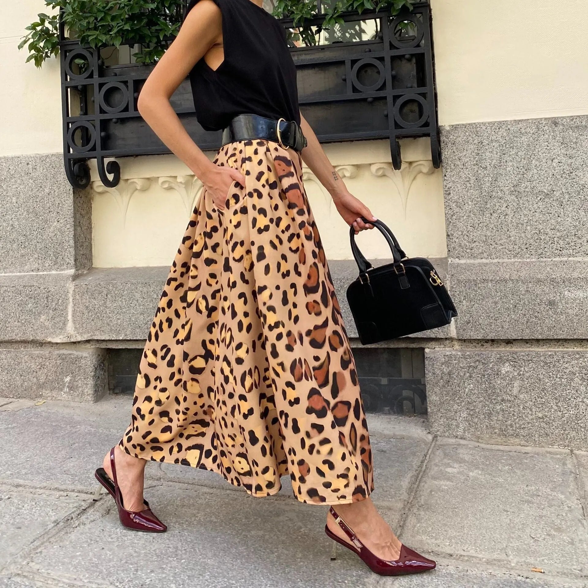 Women's brown leopard print A-line long skirt made from polyester fabric with an inelastic waist.