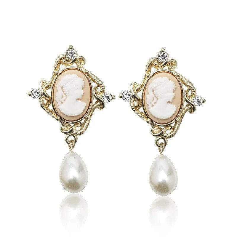Gold alloy retro embossed geometric earrings on a surface