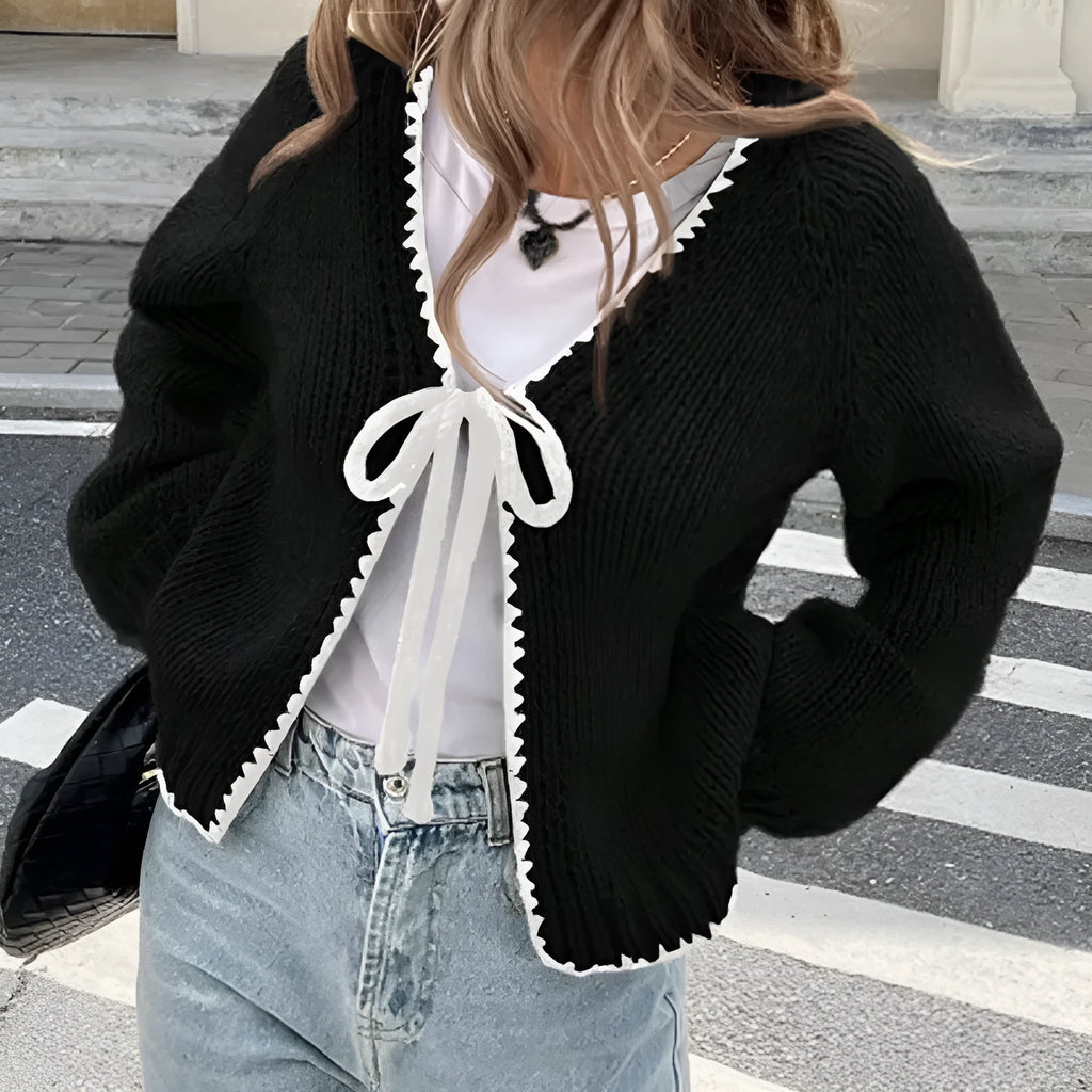 Gray lace-up cardigan sweater with long sleeves and crocheted flower decoration on the front.