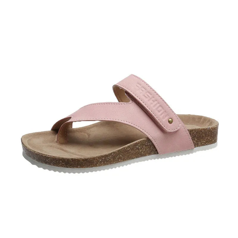 Thick-soled blue flip-flops with flat toe ring design on beach background