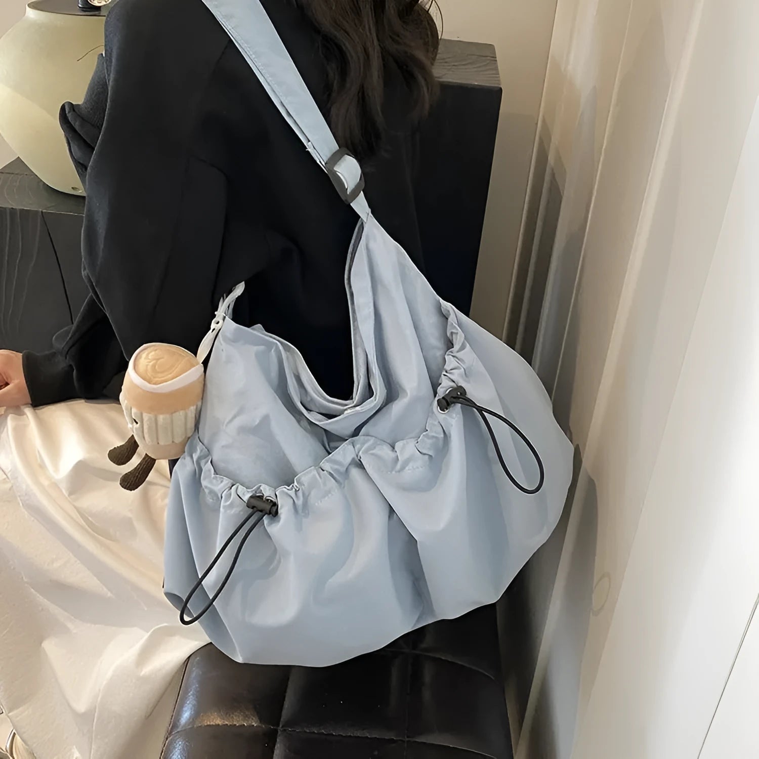 Green ultra-light pleated crossbody student bag showing folding design and split outer pocket