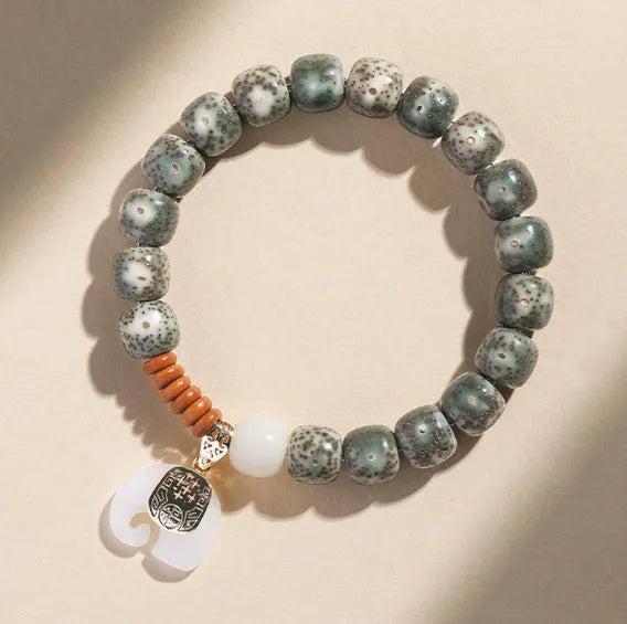 Jade green star moon bodhi bracelet with 10mm geometric beads on white background