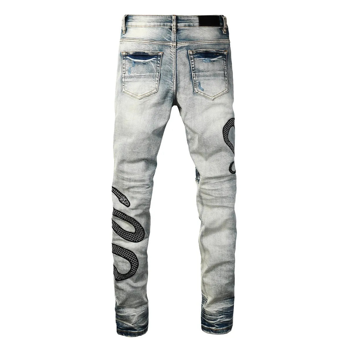 Blue distressed skinny jeans with button fly and tapered leg in street fashion style