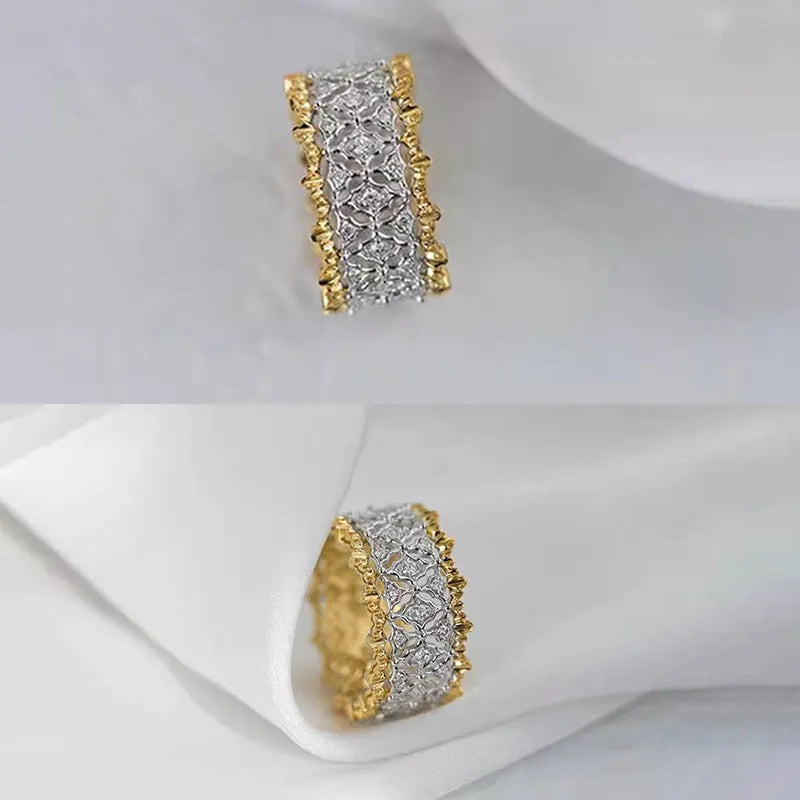 Geometric two-tone gold plated ring with round zircon centre on a plain background.