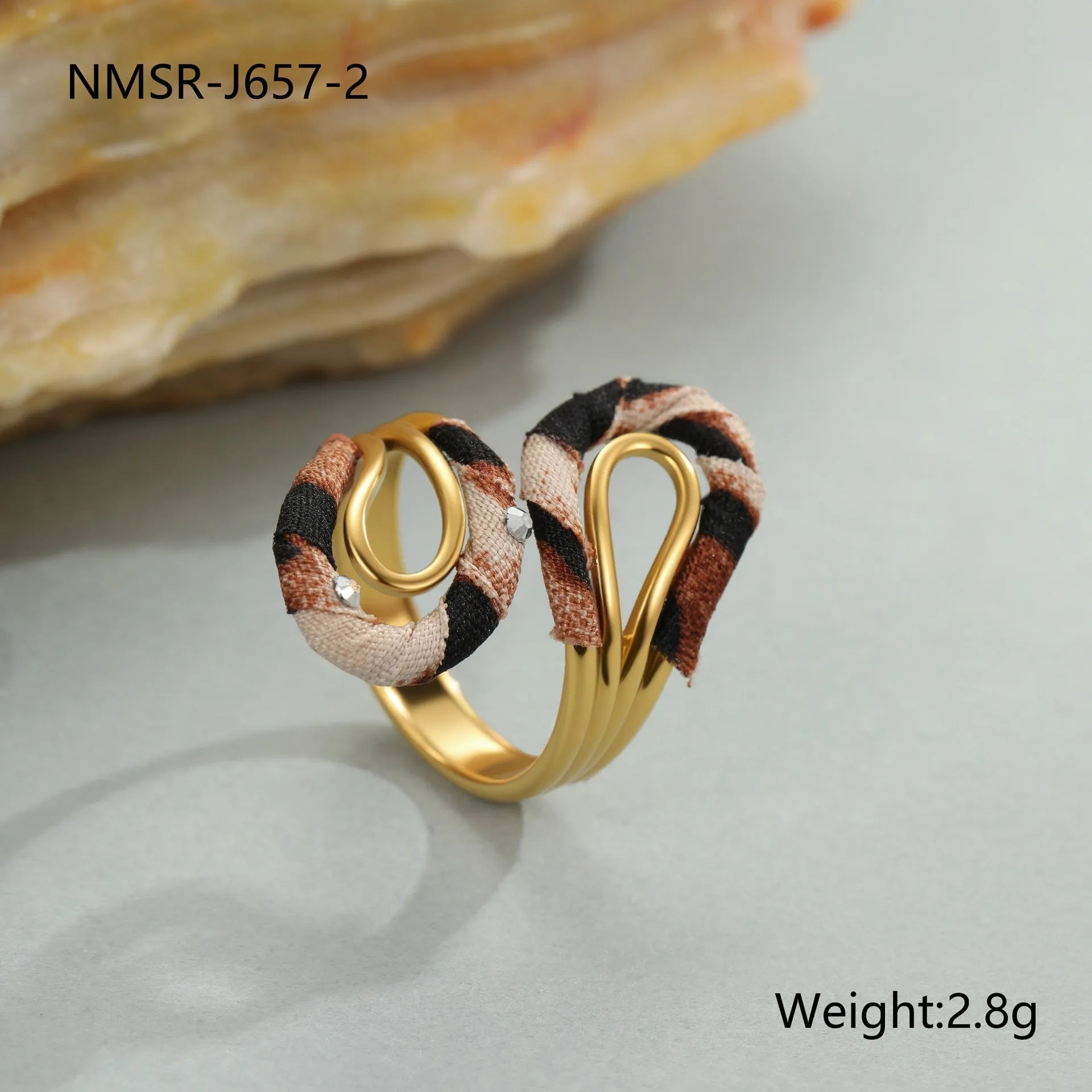 Stainless steel open mouth ring with leopard print in geometric shape on a hand.