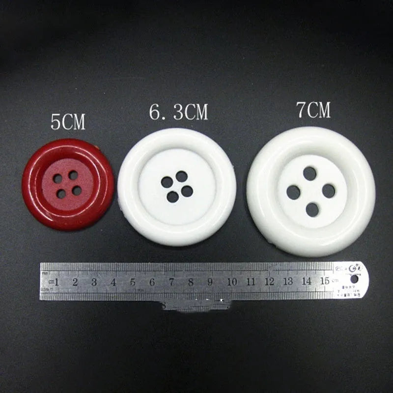Oversized round plastic sewing buttons in multiple colours with four holes