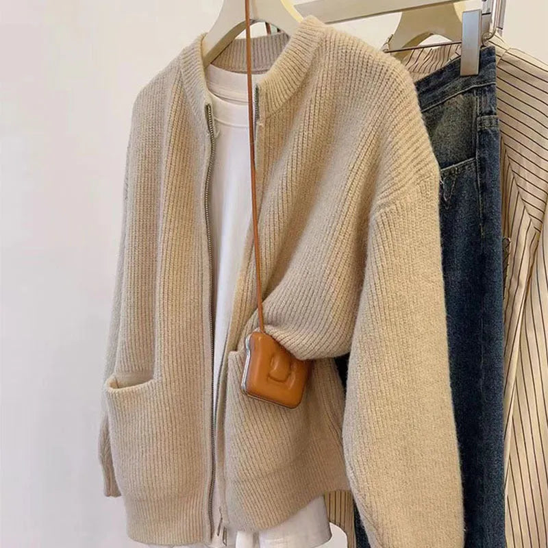 Beige viscose knit long sleeve cardigan sweater coat on a hanger