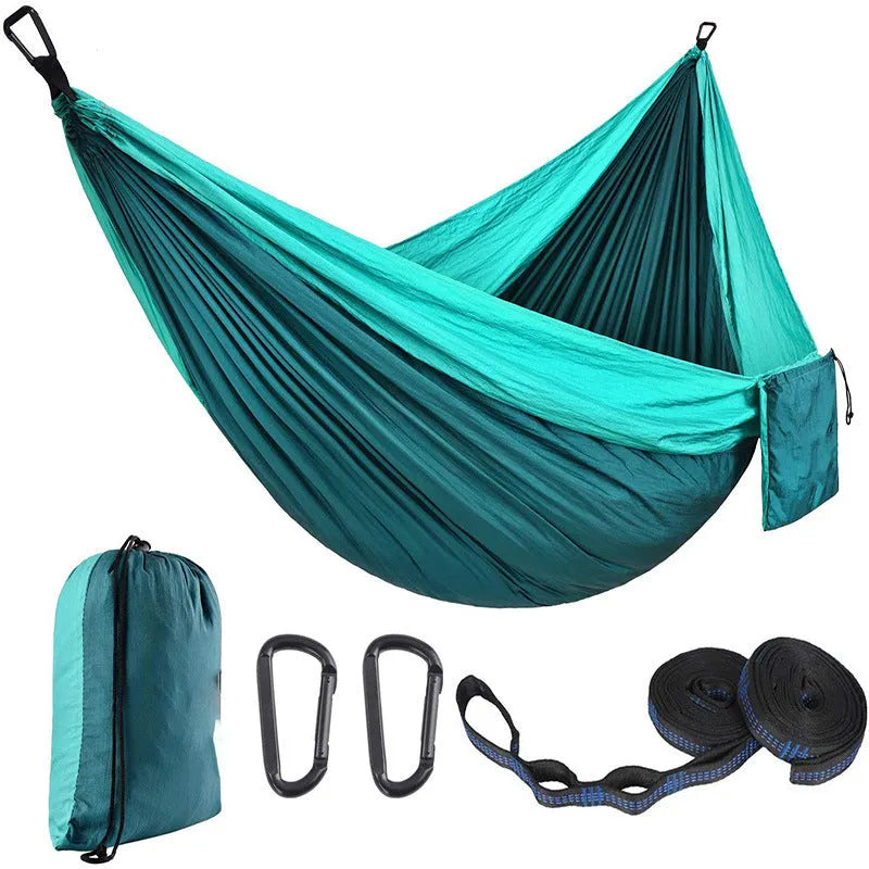 Double camping hammock with ropes and buckles shown in outdoor setting