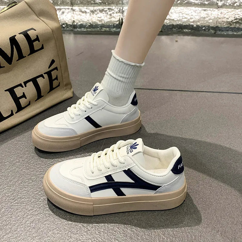 Low top blue board shoes with round toe and flat rubber sole on white background