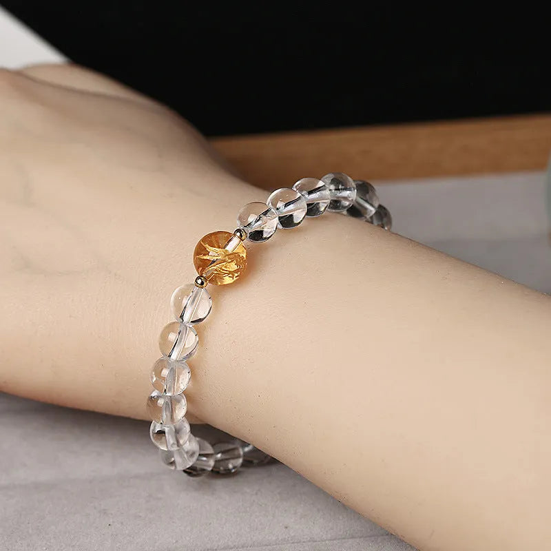 Geometric obsidian and white crystal beaded bracelet with golden dragon charm on adjustable band