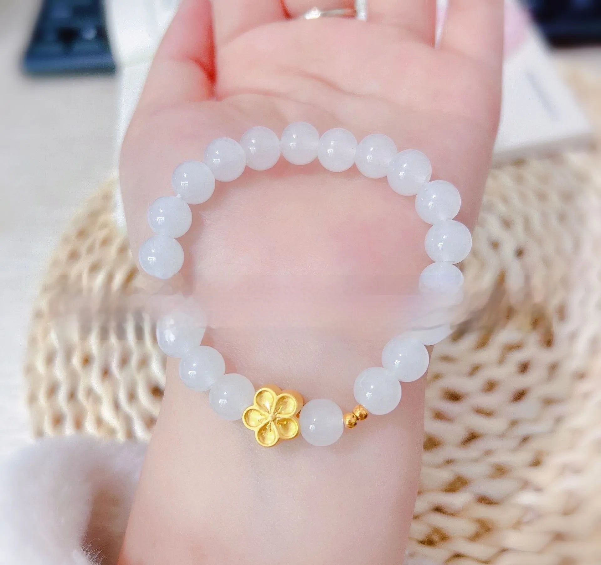 Aquamarine crystal bracelet with mixed materials including pink beads, white pearls, and peach blossom elements