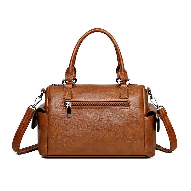 Vintage messenger bag in horizontal square shape showing stitching details and shoulder strap