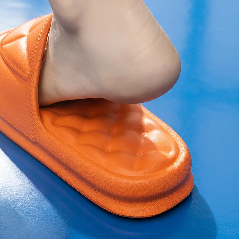 Pair of thick-soled EVA bathroom slippers in various colours, showing non-slip sole texture.