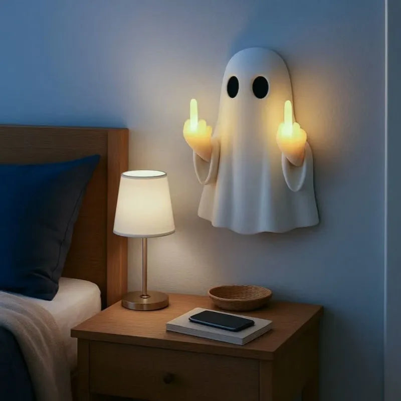 Small white modern ghost statue night light for Halloween decoration on a table.
