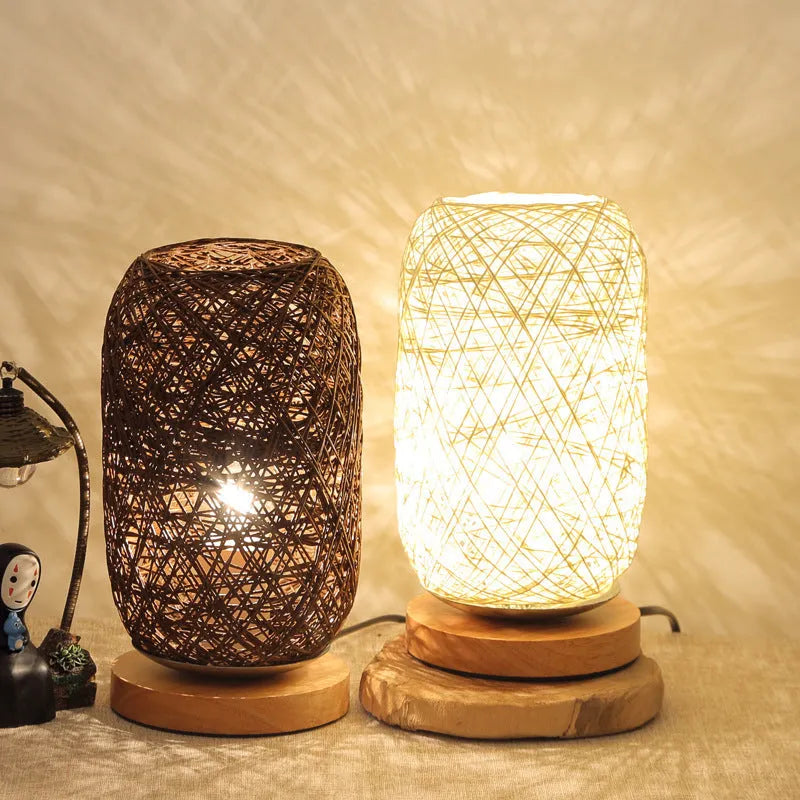 Handmade brown hemp rope spherical desk lamp with a solid wood base on a desk.