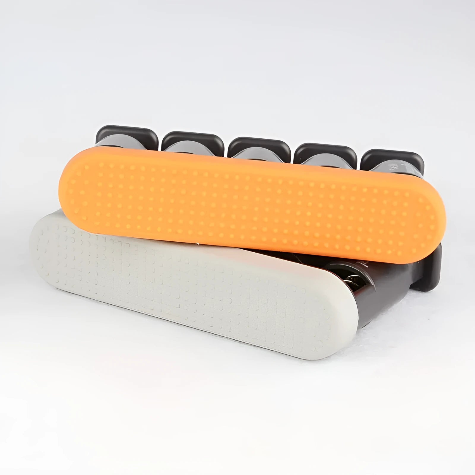 Grey and orange silicone climbing fingerboard trainer for hand strength development