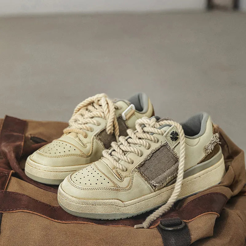 Beige vintage skateboard shoes with patch detailing, low-top design, and round toe