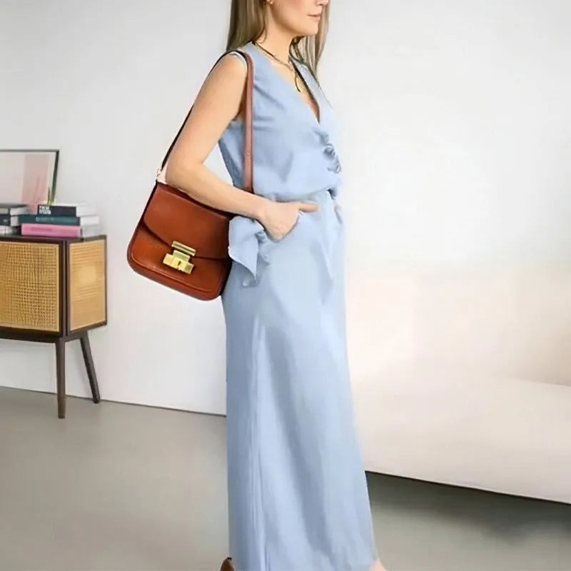 Women's blue polyester two-piece set with sleeveless vest and long skirt on a hanger.