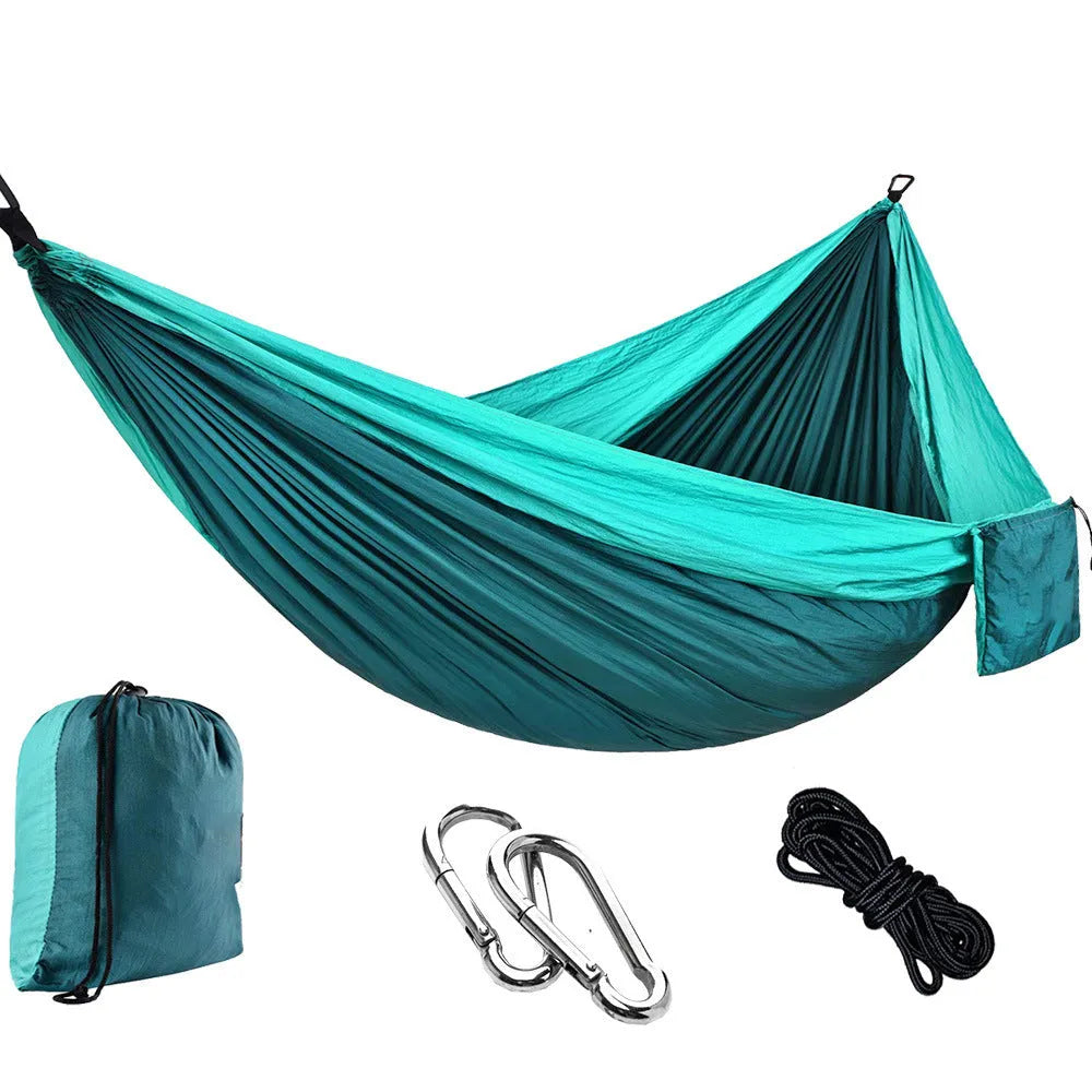 Double camping hammock with ropes and buckles shown in outdoor setting