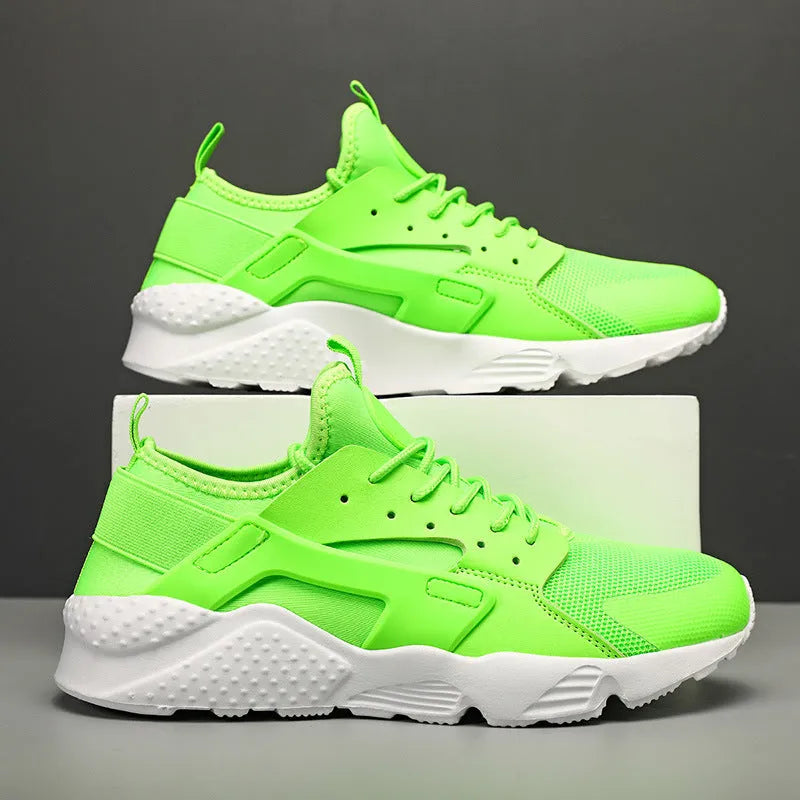 Men's green low top mesh casual shoes with lace-up front and cross straps on a flat sole.