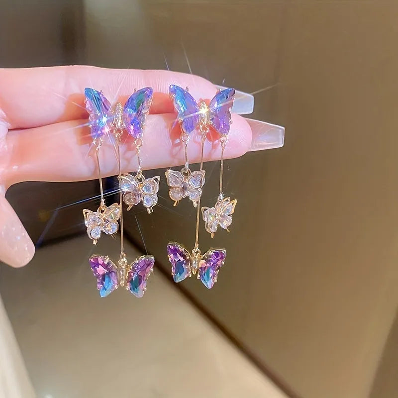 Silver electroplated butterfly tassel earrings with blue-purple crystal flowers on alloy base