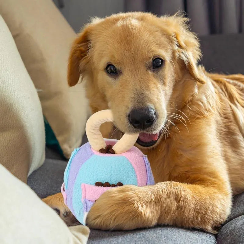 Pink and green plush ball dog toy with squeaker and treat pockets on a white background.