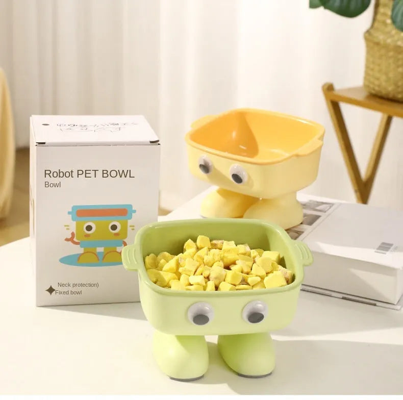 Green robot-shaped elevated cat bowl with tilted food dish and non-slip base.