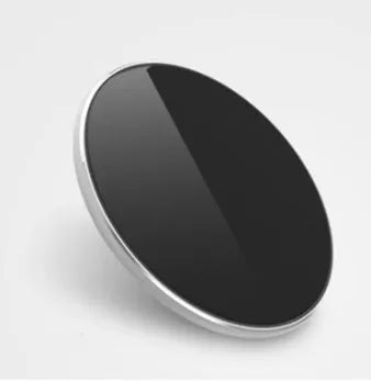 Slim aluminium wireless charging pad in rose gold colour on a wooden surface
