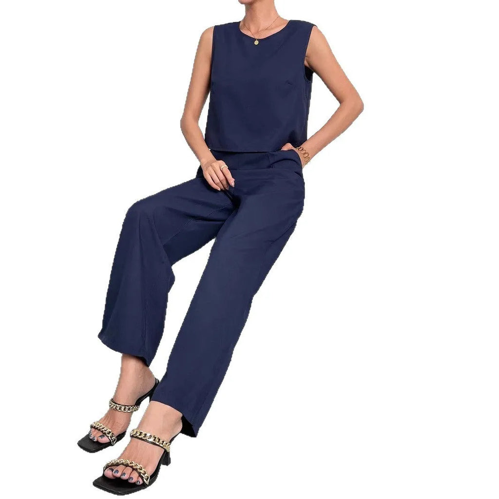 Women's red polyester two-piece set with sleeveless top and wide leg trousers on mannequin