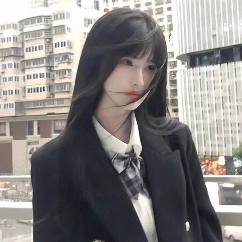 Long straight synthetic wig on a stand, shown in black colour with a full fringe.