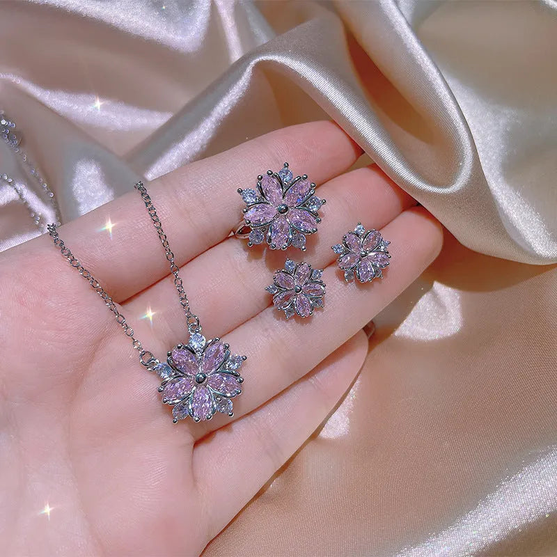 Double layer flower cubic zirconia ring necklace and stud earrings set in white copper on display