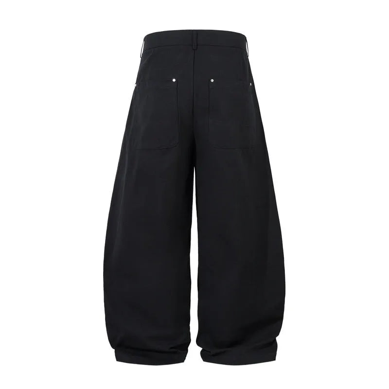 Men's black cotton loose-fit wide-leg trousers with machete pleats and an elasticated waistband