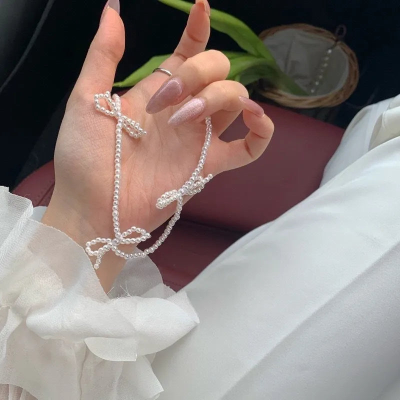 White sweet bow pearl necklace for women on an adjustable 31cm-40cm chain.