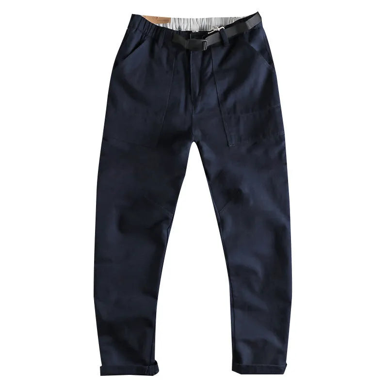 Men's khaki cotton work trousers with N I buckle belt and three-dimensional cut on a hanger.