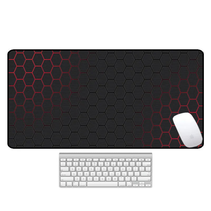 Large black rubber desk mouse pad with a printed geometric pattern, shown on a wooden desk.