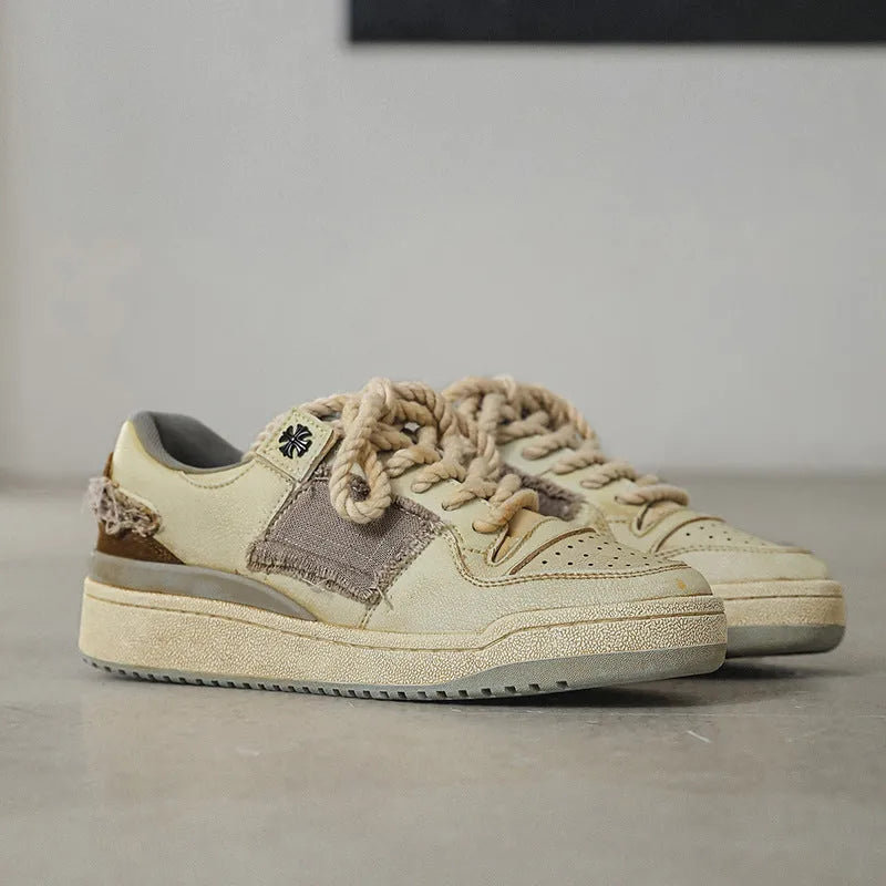 Beige vintage skateboard shoes with patch detailing, low-top design, and round toe