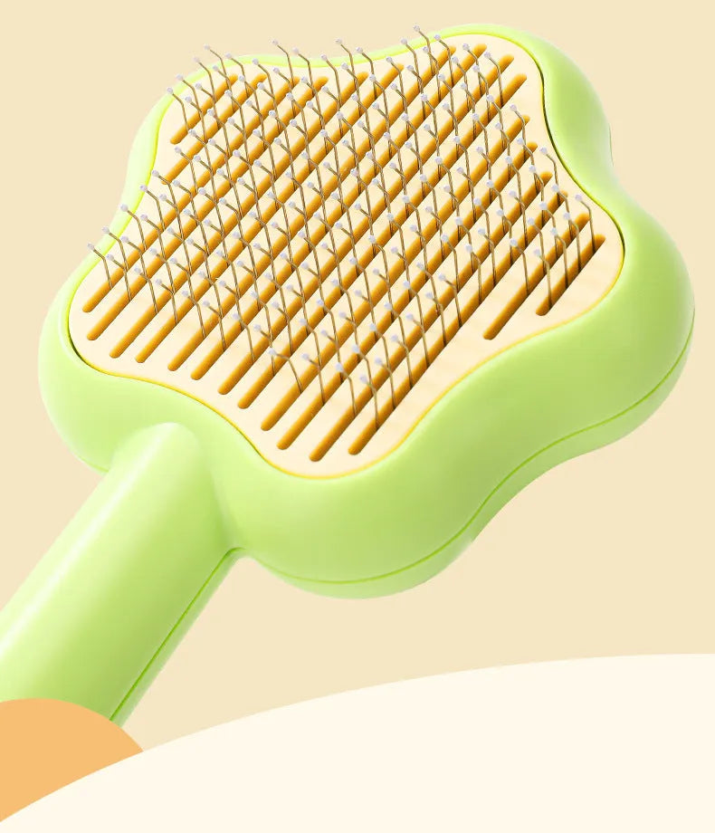 Self-cleaning stainless steel cat comb magic wand measuring 20cm with green or yellow colour options