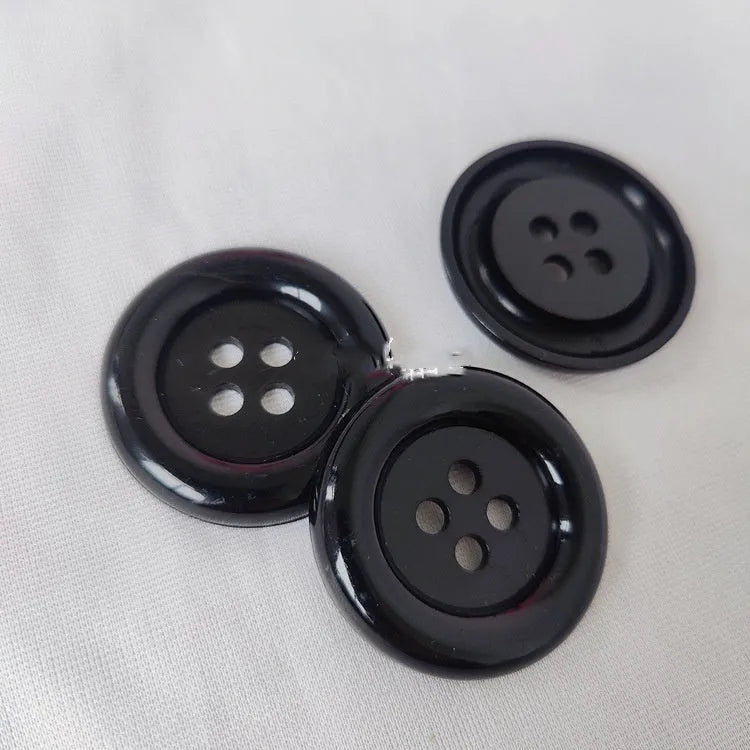 Oversized round plastic sewing buttons in multiple colours with four holes