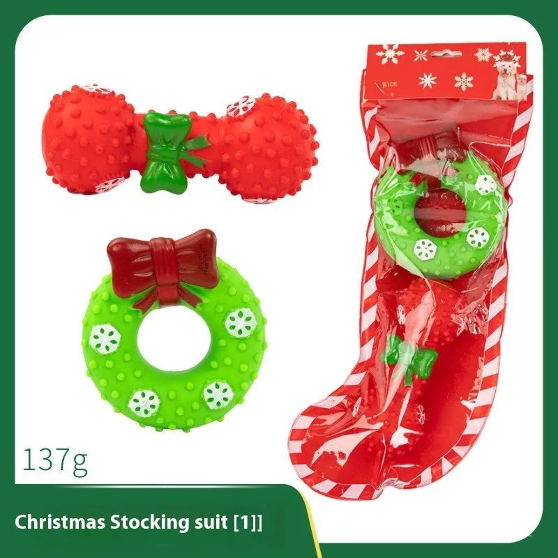 Seven Christmas gift bags containing vinyl dog toys with Santa heads, trees and deer figures